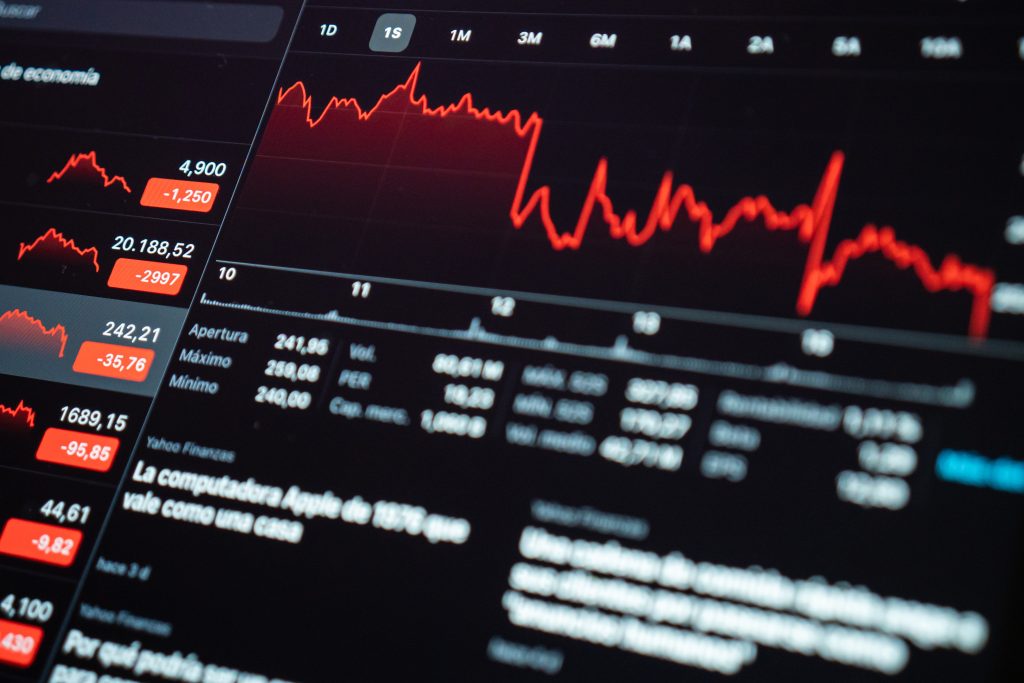 a person sitting on office table doing trading online